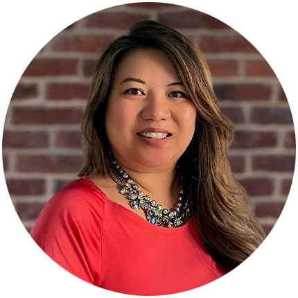 Professional headshot example of woman with brick background