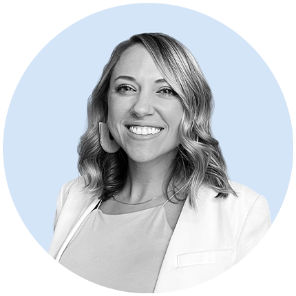 Casual headshot example of woman in black and white on light blue background shape.