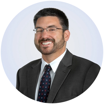 Corporate headshot example of man on light blue backdrop