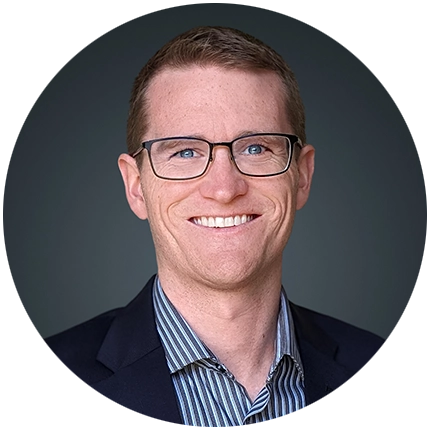 Corporate headshot example of man on dark grey backdrop