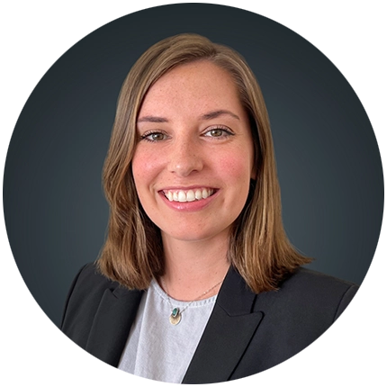 Corporate headshot example of woman on dark grey backdrop