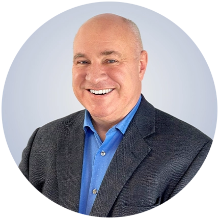 Corporate headshot example of man on light blue backdrop