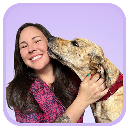 Playful headshot example of woman on purple background with a dog.