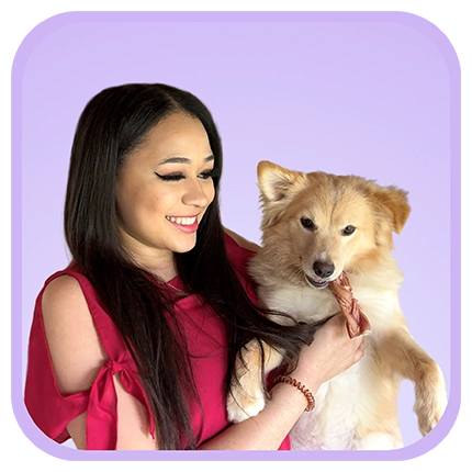 Playful headshot example of woman on purple background with a dog.